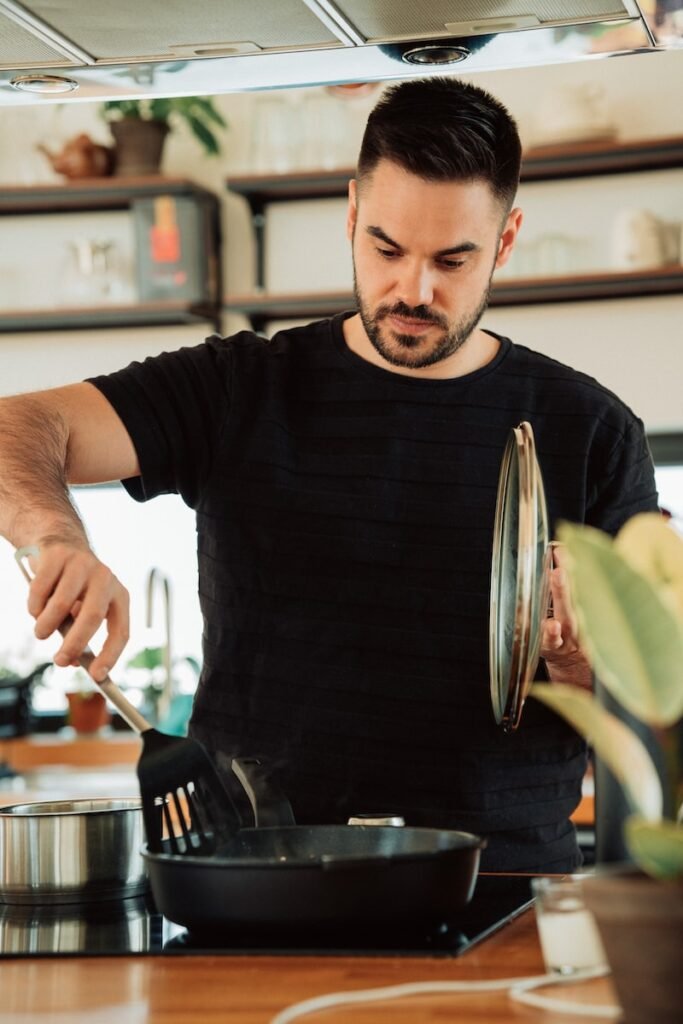 Photo by Malte Helmhold man in black crew neck t-shirt holding stainless steel fork