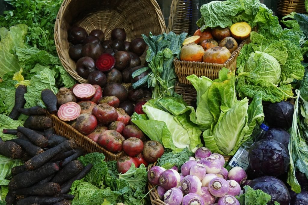 green and red vegetable on brown woven basket