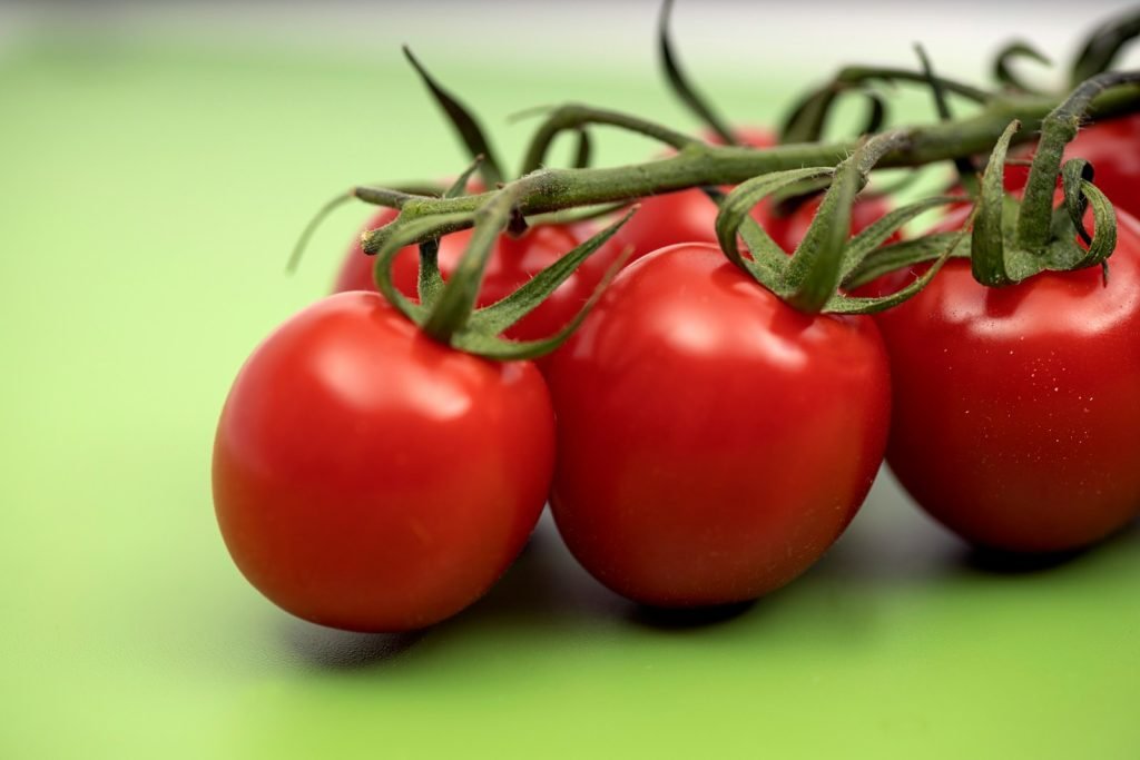 red tomato on green surface